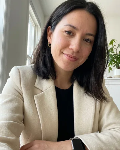 Example selfie of a woman in her 20s in a cream blazer at home